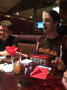 The birthday boy gabbing before opening a present.