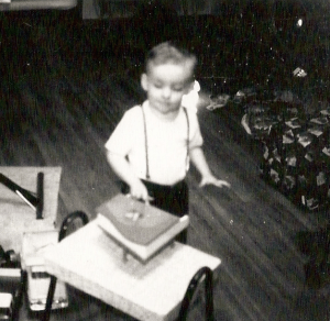 Three-year-old me at Christmas with my toy piano.