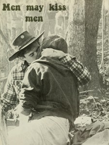Vintage photo of two men sitting in a forest and kissing. “Men May Kiss Men”